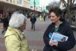 Flick talking to a voter at a street stall